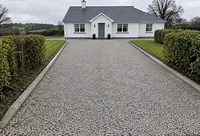 A gravel driveway with kerb edging at a country house
