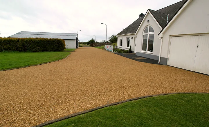 A gravel driveway and turning area at a detached house